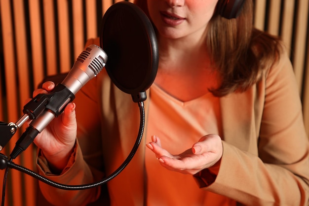 Professional singing lessons team instructor demonstrating vocal techniques for music students